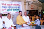 Mr. Maloji Honkalas, then Chairman, distributing free notebooks to students at free notebook distribution program organized by Patpdhi. to his right Mr. Maruti Narayankar, Secretary, to the left Mr. Keshav N. Shinde and advocate Pradip R. Kadam.
